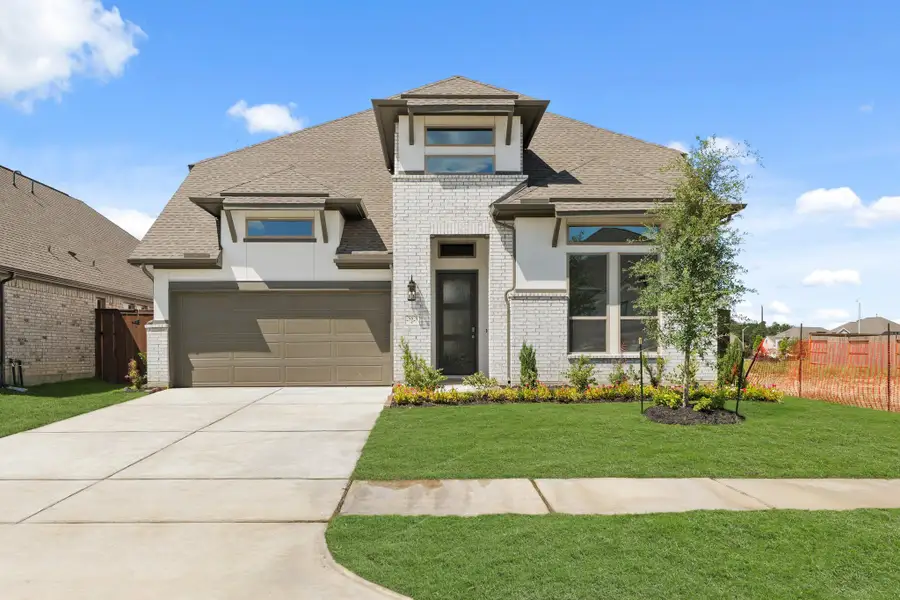 Front exterior of a new home in The Trails, New Caney, TX, highlighting curb appeal (Image 2). Front exterior of a new home in The Trails, New Caney, TX, highlighting curb appeal (Image 2).