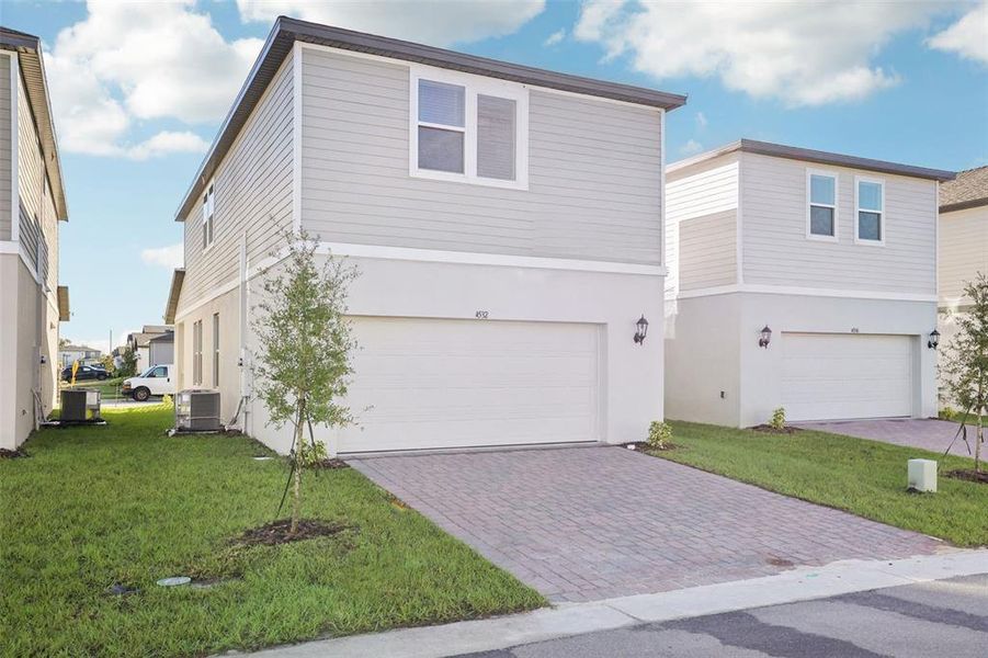 Front exterior of a new home in The Meadow at Crossprairie Bungalows, St. Cloud, FL, highlighting curb appeal (Image 29).