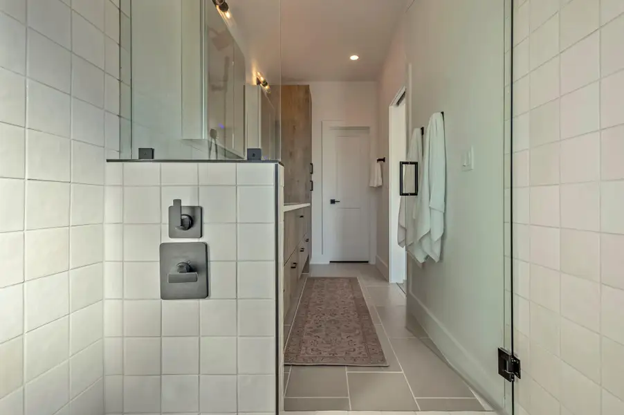 Full bath featuring a walk in shower, dual vanity, light tile patterned floors, and recessed lighting Full bath featuring a walk in shower, dual vanity, light tile patterned floors, and recessed lighting