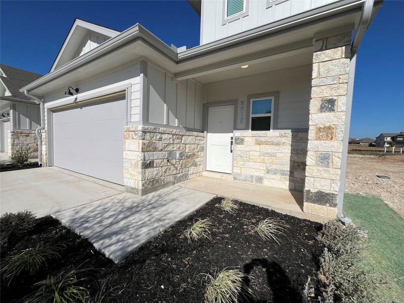 This is an exterior photo of another home that is the same floorplan/exterior colors and end townhome as 8522 Wellspring Loop