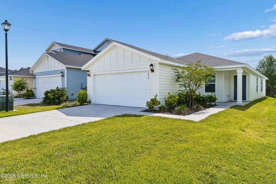 Front exterior of a new home in Lakes at Bella Lago – Classic Series, Green Cove Springs, FL, highlighting curb appeal (Image 19).