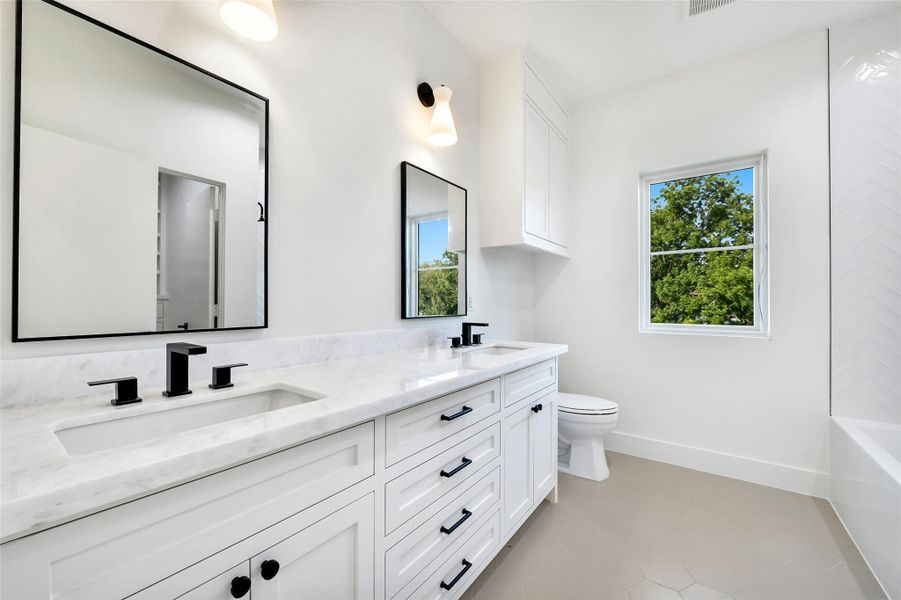 The double vanity provides ample space for storage and sprucing up. Builders example The double vanity provides ample space for storage and sprucing up. Builders example