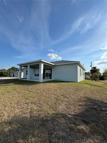 Front exterior of a new home in , Labelle, FL, highlighting curb appeal (Image 9).