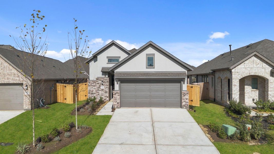Front exterior of a new home in Grand Central Park, Conroe, TX, highlighting curb appeal (Image 20).
