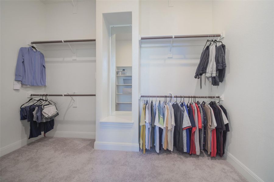 Ample hanging space and shelving create an organized wardrobe experience.
