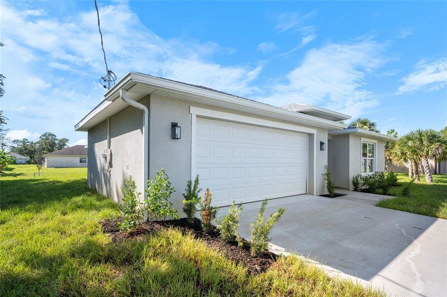 Front exterior of a new home in , North Port, FL, highlighting curb appeal (Image 14). Front exterior of a new home in , North Port, FL, highlighting curb appeal (Image 14).