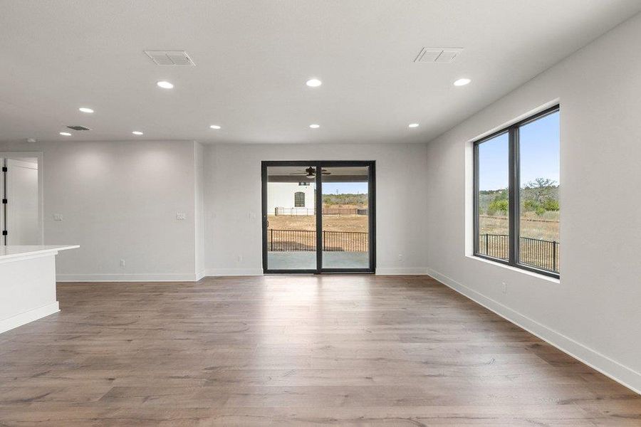 Unfurnished room featuring recessed lighting, light wood-style floors, and healthy amount of natural light