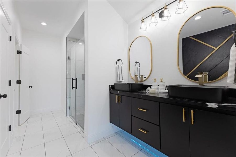 Full bathroom featuring double vanity, recessed lighting, a sink, and a shower stall