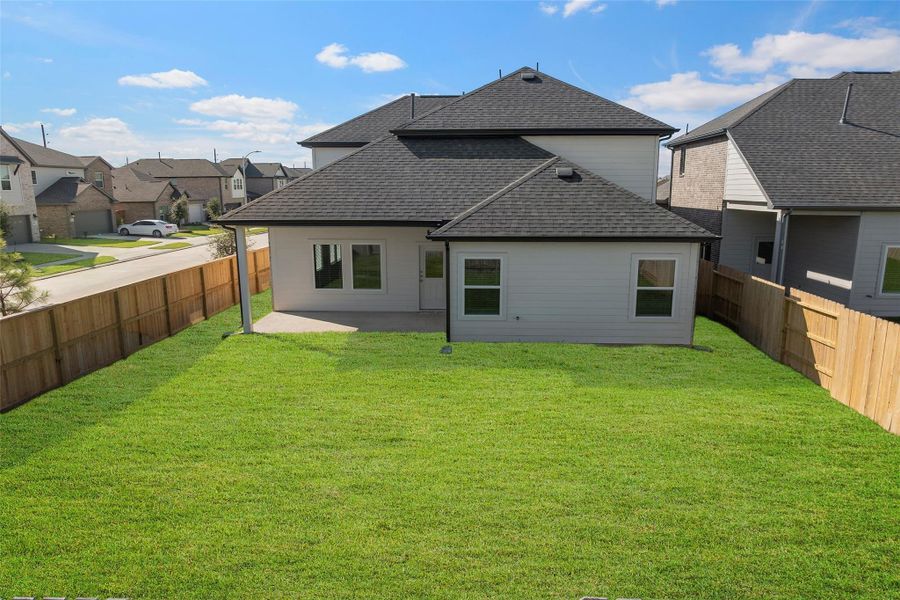 Large backyard offering room for outdoor dining, play, or future upgrades.