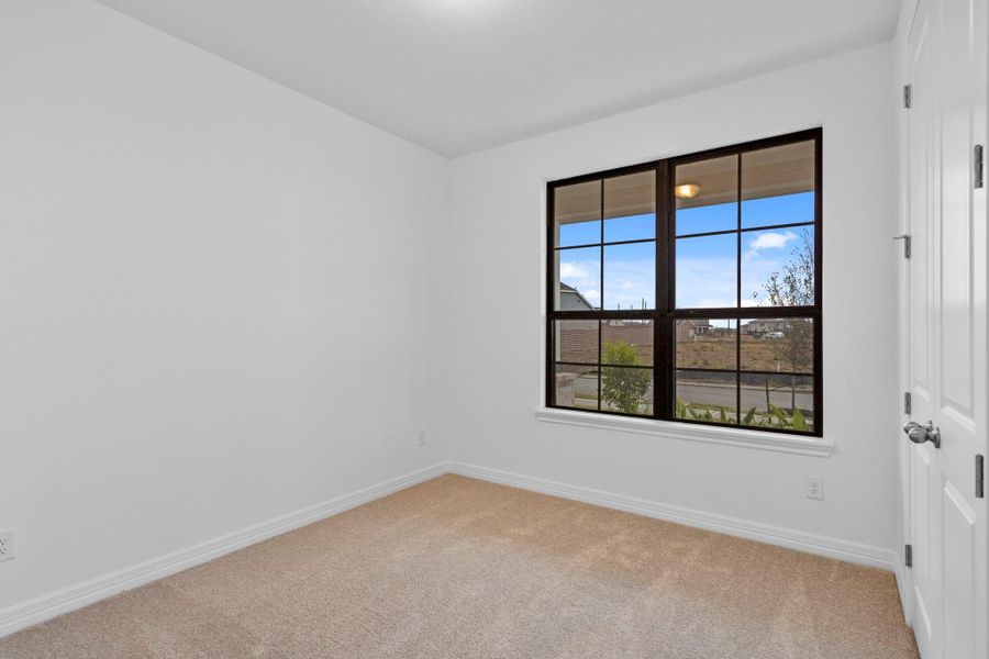 This secondary bedroom offers a serene space grounded in classic style.