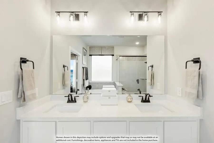 Bathroom with double sink vanity, white quartz countertop, large mirror, and glass shower visible in reflection.