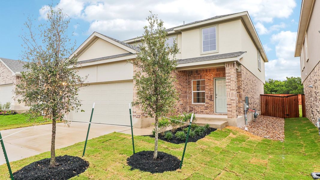 Front exterior of a new home in Bar W Ranch, Leander, TX, highlighting curb appeal (Image 2).