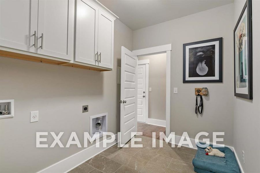 Clothes washing area featuring washer hookup, electric dryer hookup, and cabinets