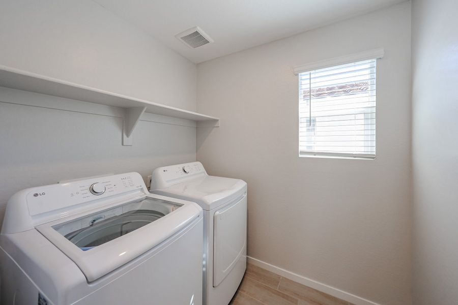 A washing machine in a room.