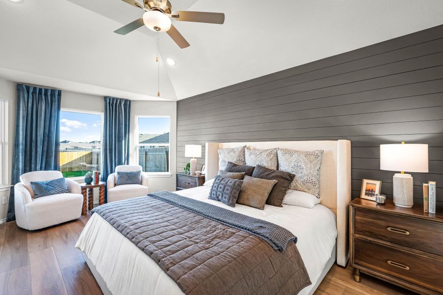 Primary bedroom in the model home located in Carillon at 13305 Eppright Trace Blvd., Manor, TX Primary bedroom in the model home located in Carillon at 13305 Eppright Trace Blvd., Manor, TX