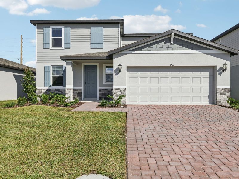 Front exterior of a new home in The Meadow at Crossprairie, St. Cloud, FL, highlighting curb appeal (Image 1).
