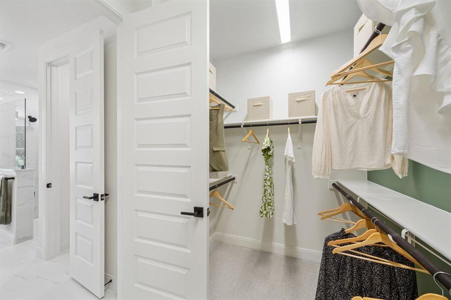 Walk-in closet featuring extensive shelving, multiple hanging rods, and recessed lighting