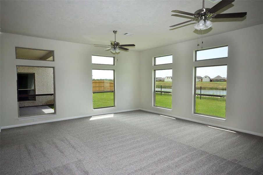 An Expansive Family Room with an abundance of natural light and a view of the lake is located off the kitchen and breakfast rooms.