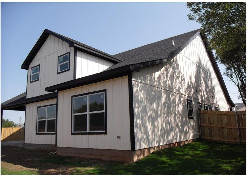 View of side of home with a lawn