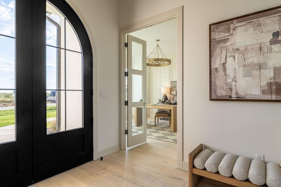 Foyer with french doors and light wood-style floors