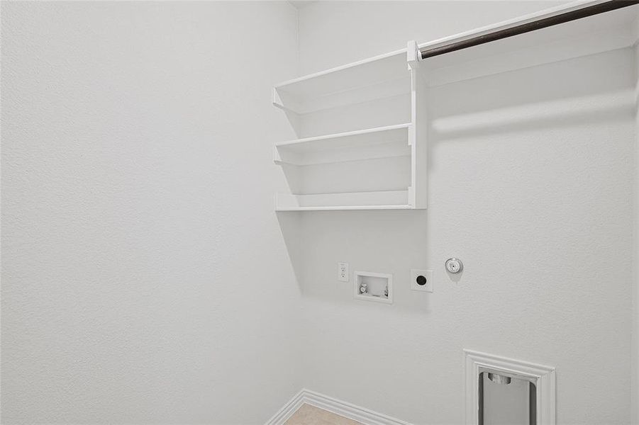 Clothes washing area with hookup for an electric dryer, gas dryer hookup, and washer hookup