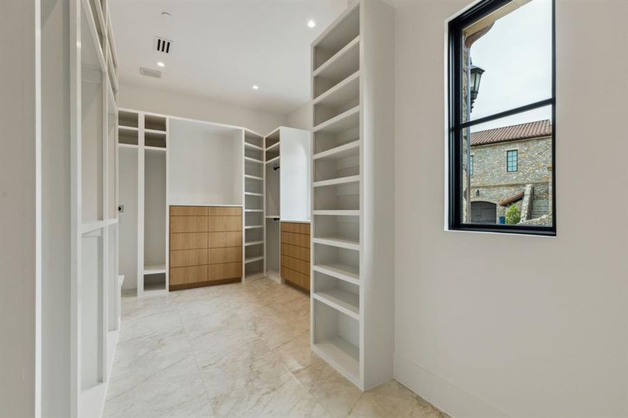 Spacious closet with light marble finish flooring Spacious closet with light marble finish flooring