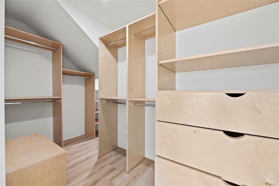 The primary walk-in closet with so much custom built-ins. Every space is used perfectly.