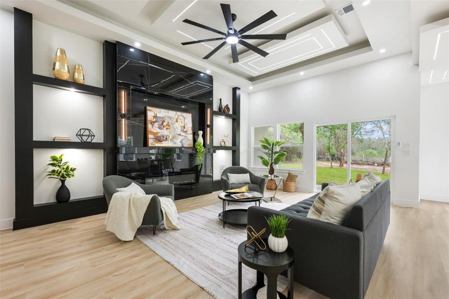 Spacious living area featuring high ceilings with recessed lighting and a large ceiling fan