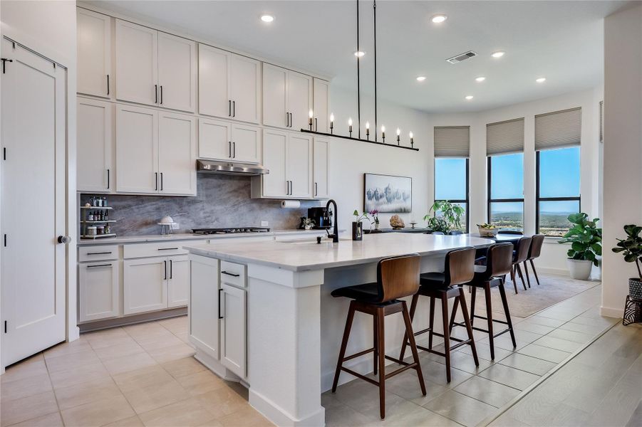 High ceilings and a massive central island define this open gourmet workspace. High ceilings and a massive central island define this open gourmet workspace.
