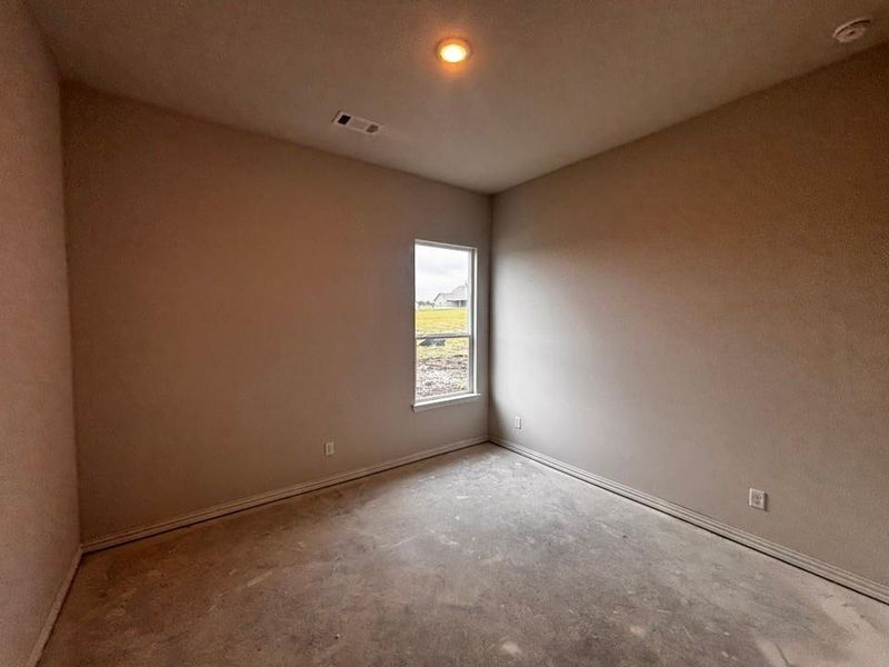 Neutral-toned interior room featuring a single window and recessed ceiling lighting