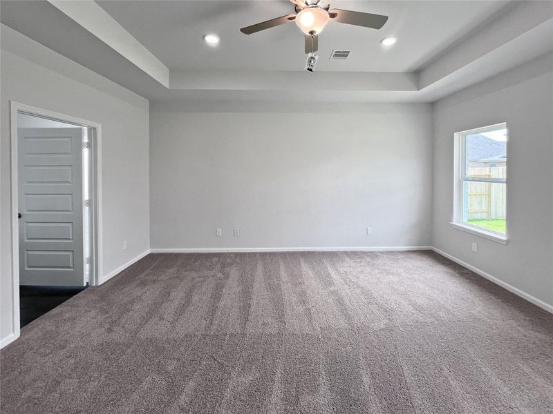 The Crawford- Primary Bedroom with Tray Ceiling. Home under construction. Sample floor plan photo used for illustrative purposes only. Upgrades, selections options, windows and colors may vary. The Crawford- Primary Bedroom with Tray Ceiling. Home under construction. Sample floor plan photo used for illustrative purposes only. Upgrades, selections options, windows and colors may vary.