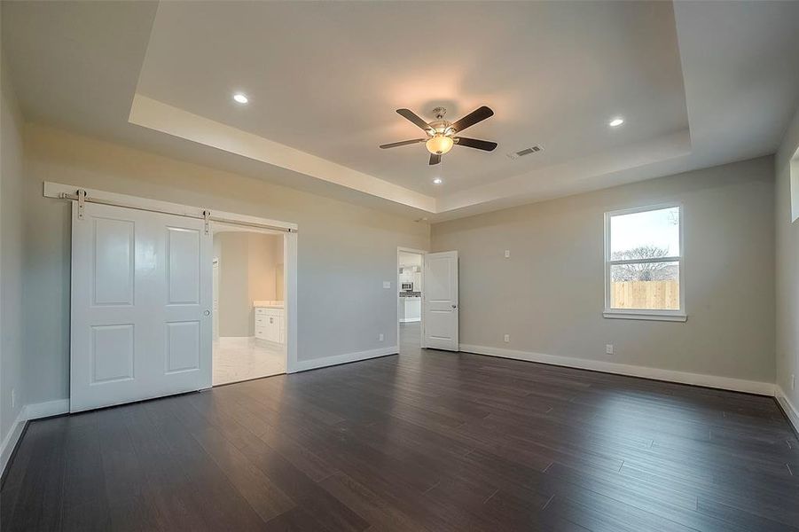 Primary bedroom with vaulted ceilings