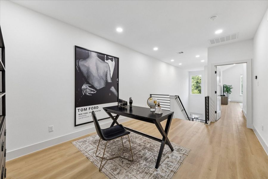 A flexible bonus room adapts effortlessly as a home office, fitness studio, media lounge, or creative workspace while continuing the home’s cohesive architectural design.