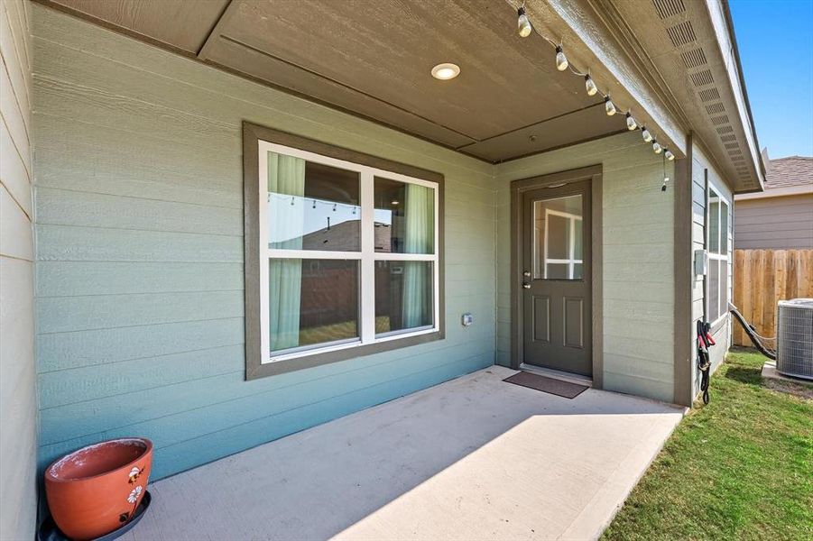 Doorway to property with a patio area