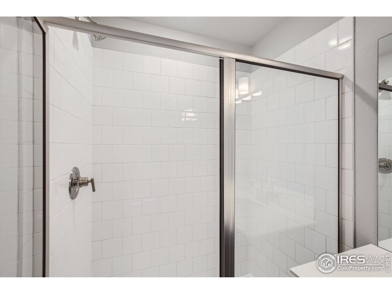 Tiled shower in Primary Bathroom.