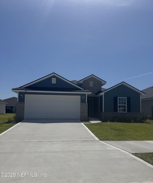 Front exterior of a new home in Summerglen, Jacksonville, FL, highlighting curb appeal (Image 13).