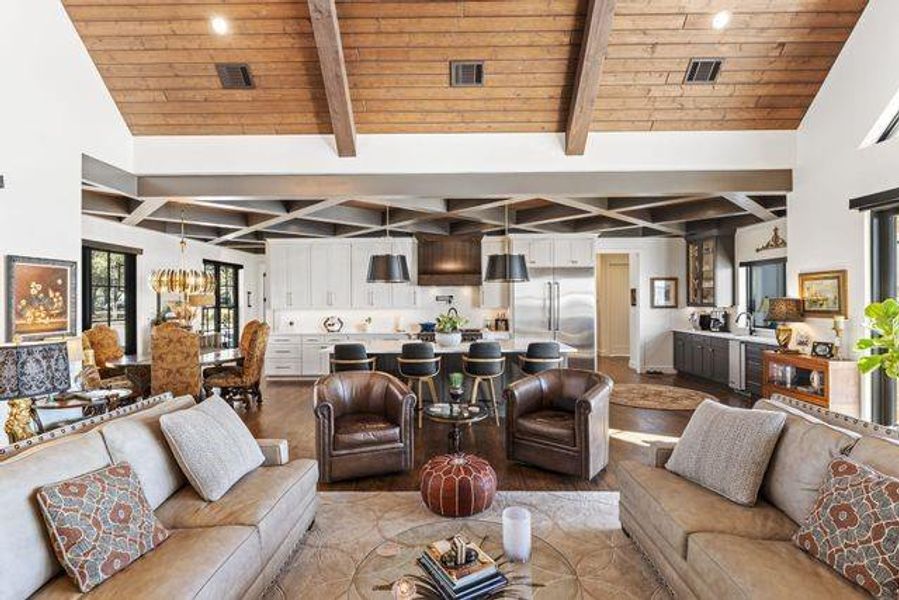 Living Room with a wooden ceiling with exposed beams and high vaulted ceiling