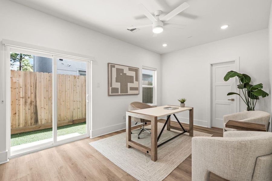 Framed by soft natural light and opening to a private turfed yard, this versatile space offers a seamless connection between indoors and out.
