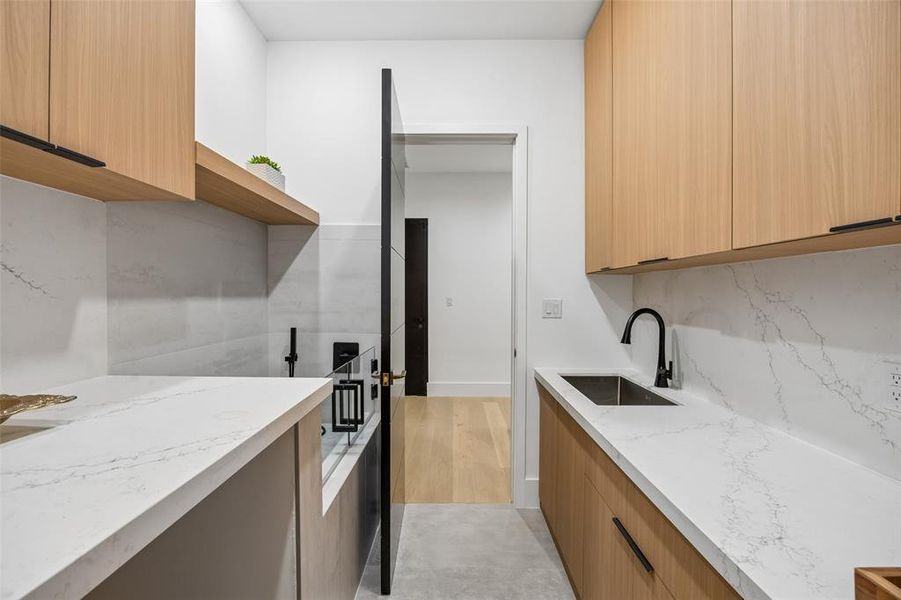 Full catering kitchen with electric cooktop, oven, sink, dishwasher and refrigerator.