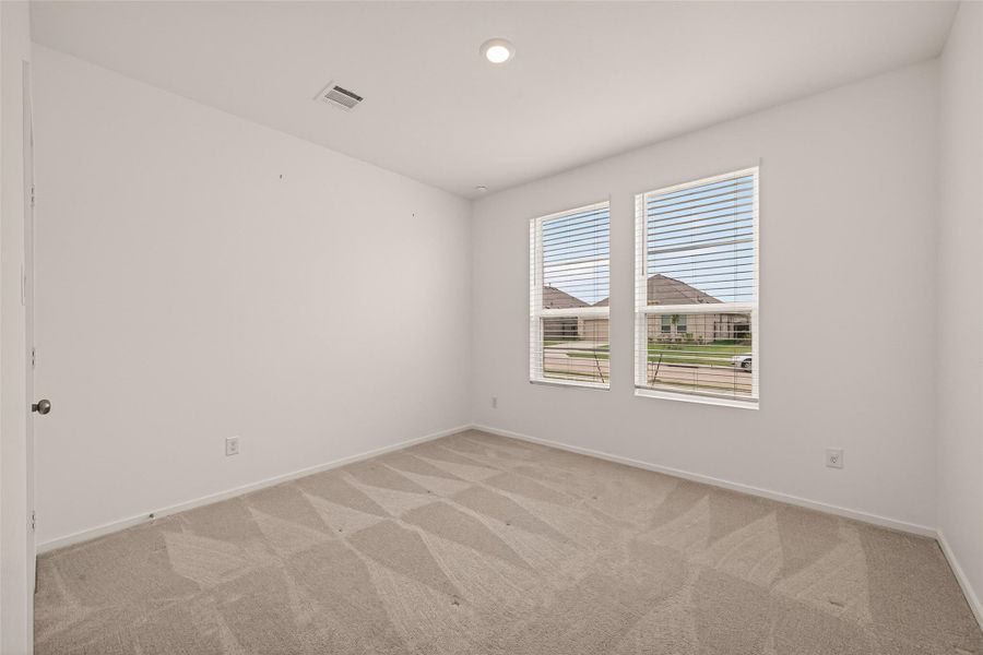 Comfortable secondary bedroom with great natural light and flexible space for guests, family, or a home office.