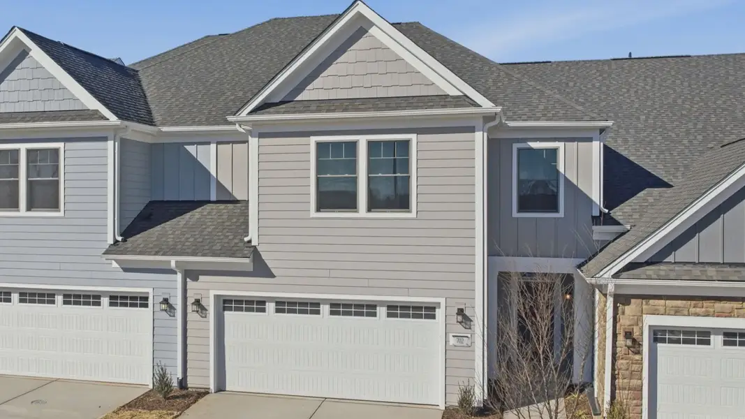 Front exterior of a new home in The Courtyards at Oak Grove, Durham, NC, highlighting curb appeal (Image 2).
