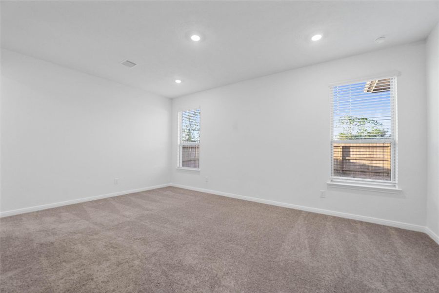 Unwind in your private sanctuary. This tranquil primary suite is a true retreat, offering a sense of calm and luxury. With a spacious layout, walk-in closet, and en-suite bath, it's the perfect place to start and end your day.