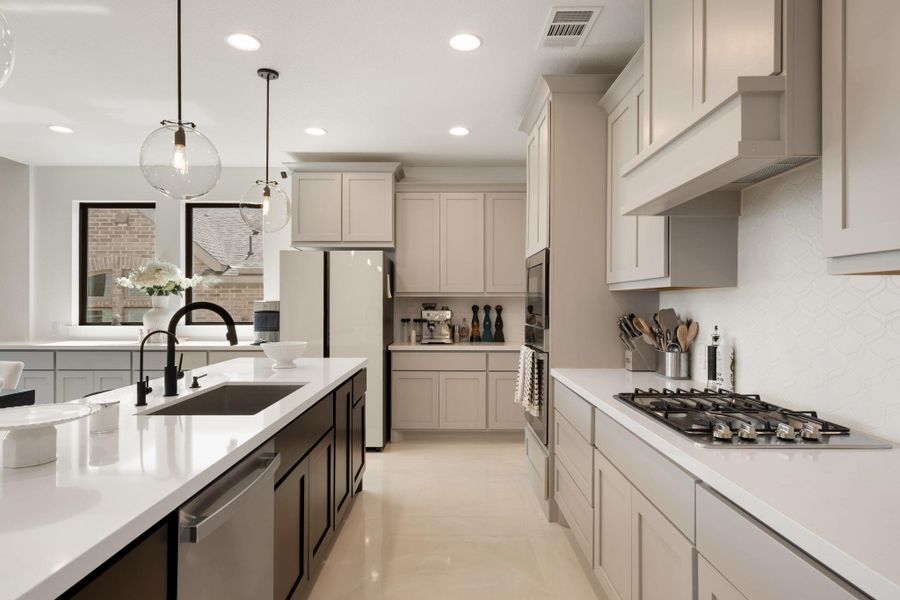 A well-appointed kitchen features ample counter space, modern appliances, and stylish pendant lighting. A well-appointed kitchen features ample counter space, modern appliances, and stylish pendant lighting.