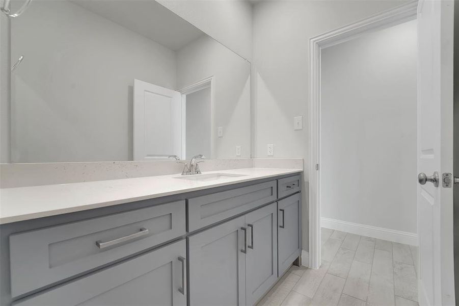Bathroom featuring vanity and baseboards Bathroom featuring vanity and baseboards