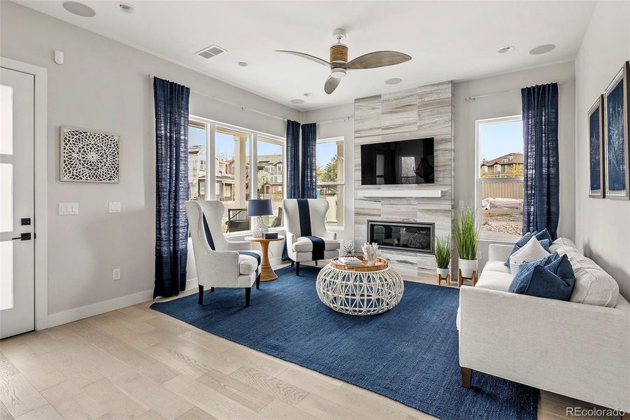 Living room surrounded by west and south-facing windows, gas fireplace Living room surrounded by west and south-facing windows, gas fireplace