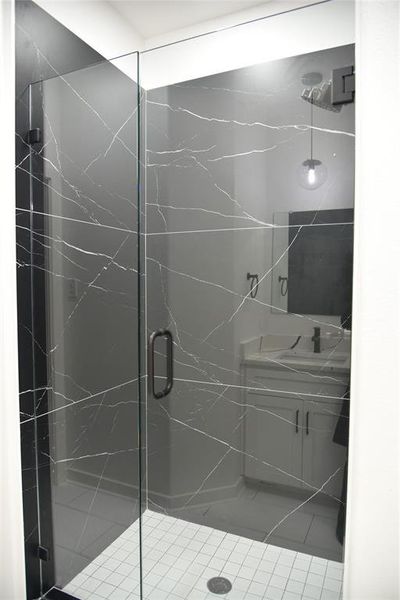 Bathroom with vanity and a shower with door