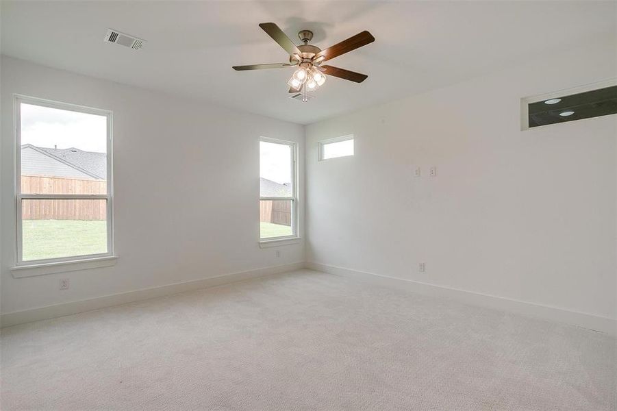 Unfurnished room with ceiling fan and carpet floors