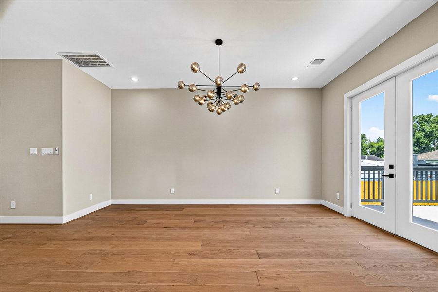 Spacious family room featuring a modern light fixture and abundant natural lighting. Spacious family room featuring a modern light fixture and abundant natural lighting.