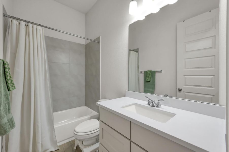 This secondary bathroom at the front of the home, shared by two bedrooms and ideal for guests. This secondary bathroom at the front of the home, shared by two bedrooms and ideal for guests.