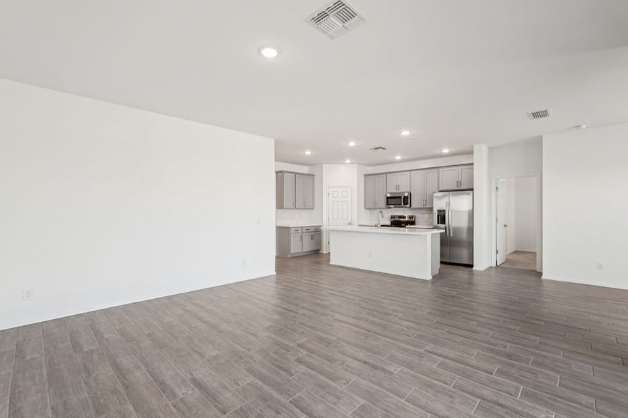 Great room and kitchen. Finishes and options may vary by community